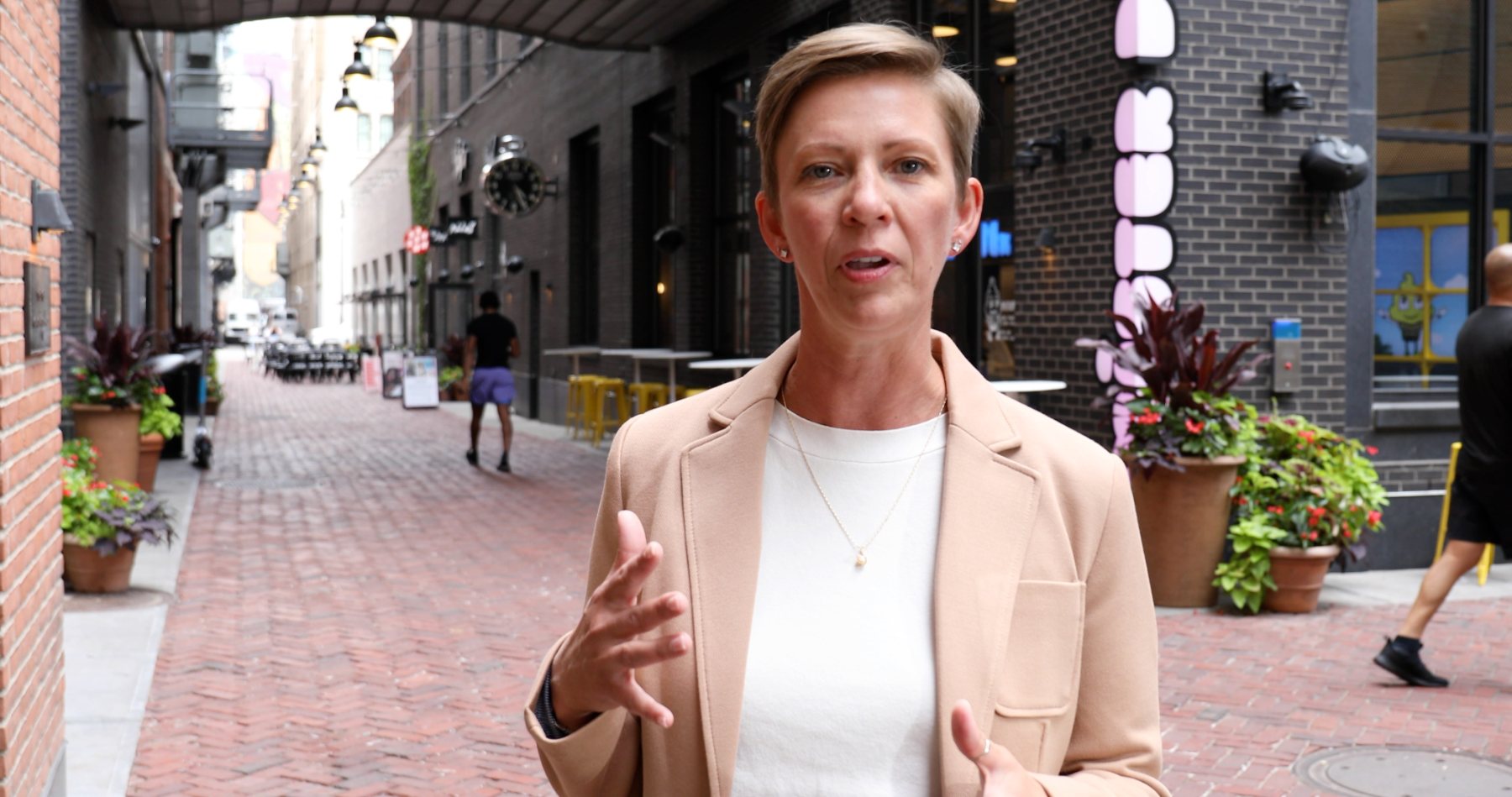 Jessica Robinson speaking on a brick alley in downtown Detroit